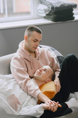 Young romantic gay couple spending day cuddling