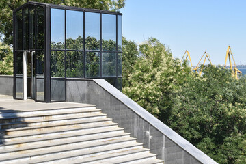cube-shaped building near the sea station, concrete staircase