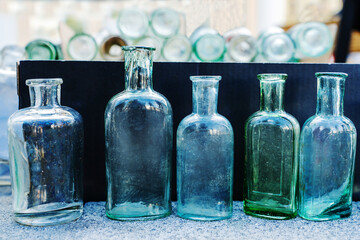 Antique glass bottles of small sizes and different shapes. Archaeological finds of the 19-20 century. Close-up