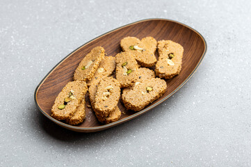 Gajak or til patti is a dry sweet cake - made of sesame seeds, ground nuts and jaggery, consumed in India  especially in winter during Makar Sankranti and Lohri festival