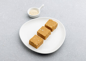 

Til mawa cake or Gajak  is a dry sweet cake - made of sesame seeds, ground nuts and jaggery, consumed in India  especially in winter during Makar Sankranti and Lohri festival