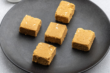 

Til mawa cake or Gajak  is a dry sweet cake - made of sesame seeds, ground nuts and jaggery, consumed in India  especially in winter during Makar Sankranti and Lohri festival