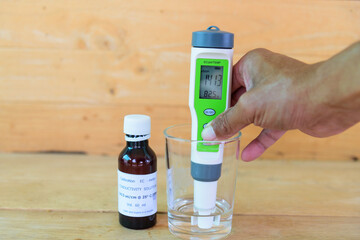 The man calibrate Ph meter before use it for tester