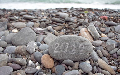 stone with 2022 inscription by the sea