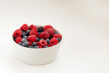 raspberries and blueberries  in a bowl