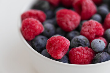 raspberries and blueberries  in a bowl