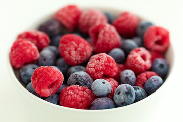 raspberries and blueberries  in a bowl