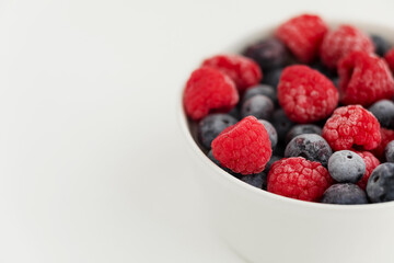 raspberries and blueberries in a bowl