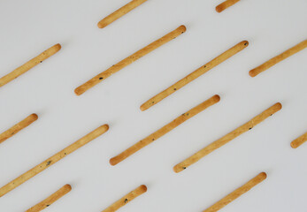 Pattern created by sesame stick snackers in white background