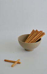 Korean sweet sesame seeds stick biscuits in a bowl against white background