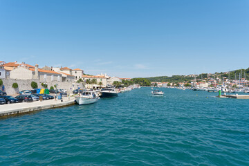 Fototapeta na wymiar Entering the port of the town of Rab on the island of the same name in Croatia on the Adriatic Sea