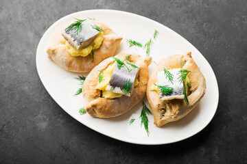 Delicious tapas herring appetizer. Puff pastry boats, mashed potatoes and dill herring slices. Top view. Catering, holiday, picnic