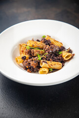 fagioli pasta with beans rigatoni or tortiglioni Italian food healthy meal diet snack on the table copy space food background rustic. top view
