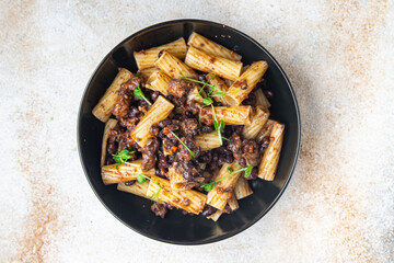 fagioli pasta with beans rigatoni or tortiglioni Italian food healthy meal diet snack on the table copy space food background rustic. top view