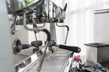 Close-up of espresso pouring from coffee machine. coffee extraction from professional coffee machine with bottomless filter and steam, barista preparing coffee at cafe