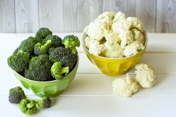 fresh broccoli and cauliflower in bowls on the table. white background with fresh broccoli and cauliflower.
