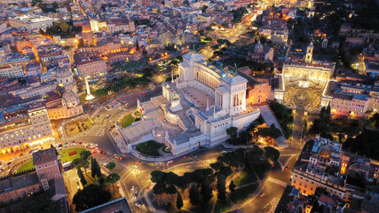 Aerial drone night shot of iconic monument in Venice square called Altar of the Fatherland at dusk with beautiful colours, Rome historic centre, Italy
