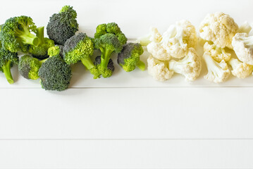 fresh broccoli and cauliflower on the table. white background with fresh broccoli and cauliflower. copy space and vegetables.