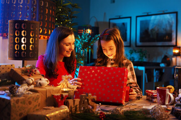 Cute daughter unboxing the Christmas present - electronic device