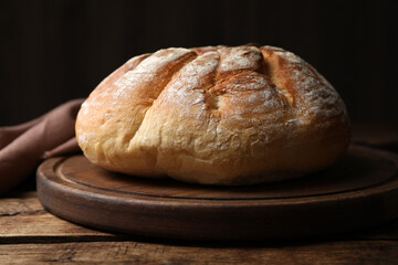 Loaf of tasty wheat sodawater bread on wooden table