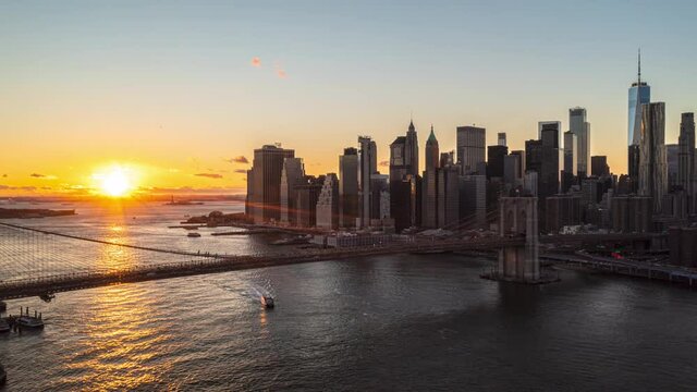 Picturesque hyperlapse footage of flight over big cable-stayed bridges at romantic sunset. Group of modern downtown skyscrapers. Manhattan, New York City, USA