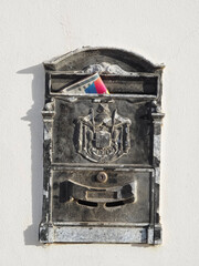 Antique metal letter box with mail