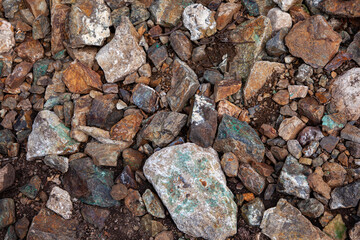 Natural gravel stones texture. Gravel colorful rock texture. Background with stones and rocks in brown and green.