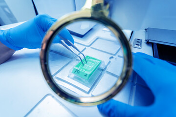 Laboratory assistant works at paraffin wax dispenser tissue embedding machine.