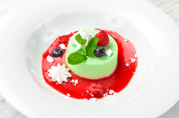 Dessert. Mint panna cotta with ice cream on a plate. Top view.