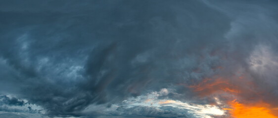 Russia. The South of Eastern Siberia. Gloomy sunset clouds in the evening summer sky over the mountain ranges of Eastern Sayan.