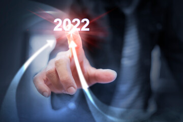 Businessman pointing arrow graph corporate future growth in the year 2022, Development to success and motivation.
