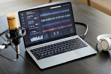 Background image of recording studio setup with microphone and audio tracks on laptop screen, copy...