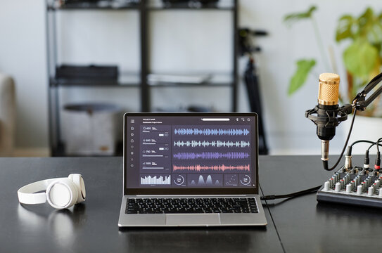 Background image of recording studio with microphone and audio tracks on laptop screen, copy space