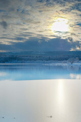 Winter forest near the lake. Sunny and snowy day. HDR landscape.