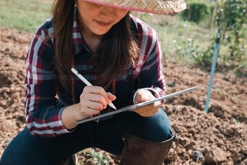 The girl is studying and recording the changes in the natural flora of the farmer.
