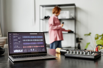 Background image of recording equipment and laptop with audio tracks in studio, copy space © Seventyfour