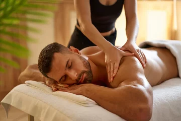 Photo sur Plexiglas Salon de massage Young man having a massage by a professional masseuse