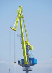 Port cargo crane over blue sky