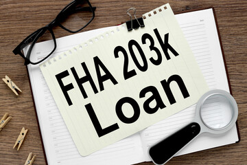 FHA 203(k) Loan. text on white paper. paper lies on a notebook on a wooden background