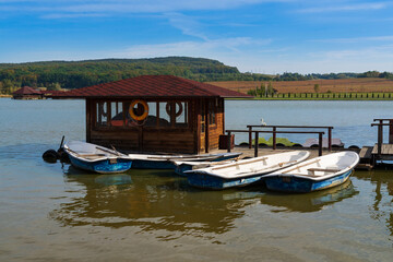 Wooden pier with boats on a country lake In Chernivtsi. Ukraine 10.3.2020