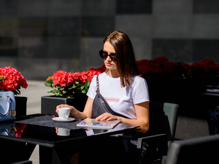 fashionable girl walks around the city of Minsk. The inscription on the T-shirt 