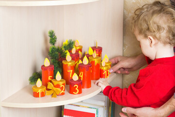 Unpacking Handmade advent calendar. Kids hands with Christmas candle craft. Seasonal eco activity. Reuse concept