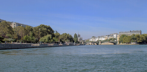 Fototapeta premium A boat ride on the river Seine and enjoying the beauty of Paris - France 