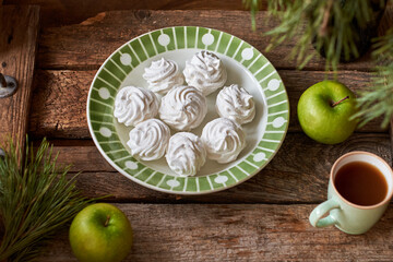 Russian homemade marshmallow, zefir, zephyr. Wooden background, side view. blueberries, spruce branches, apple 