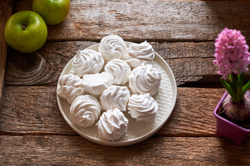 Russian homemade marshmallow, zefir, zephyr. Wooden background, side view, apple , hyacinth