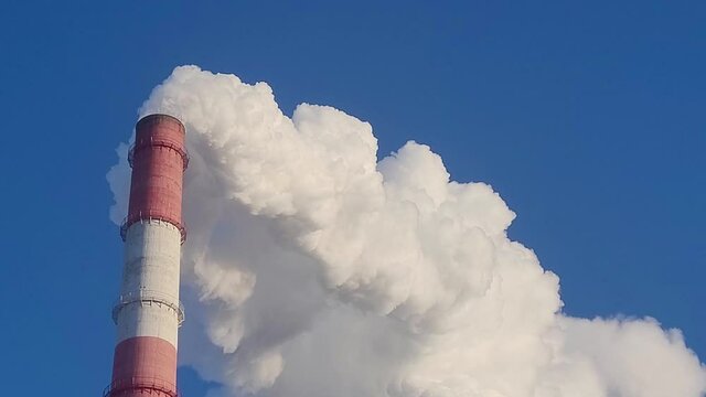 Industrial, ecology and environmental pollution. The smoke from the chimney of the industrial plant.