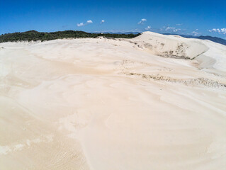 Fototapeta premium Dunes with vegetation and lake in background