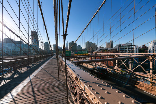 New York, USA - 2021: Brooklyn Bridge, built in 1883, was the first fixed crossing of the East River. Photo taken during the day with blue sky and view to the beautiful Manhattan.