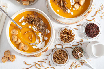 Close-up of edible insects in pumpkin soup, mealworms