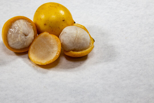 Ripe Achachairu fruit ( Garcinia humilis ), in selective focus and white background.